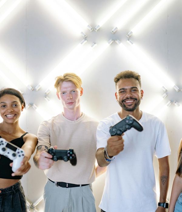 Group of diverse people in a bright yoga studio smiling.