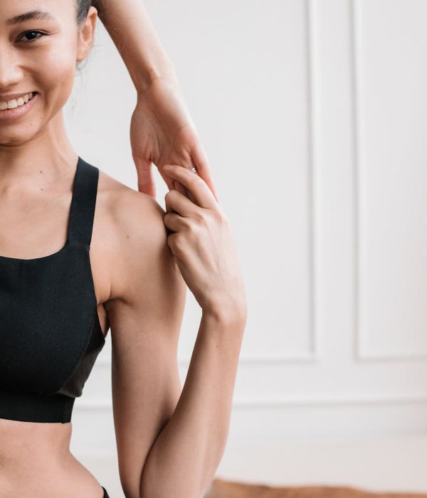 Portrait of Alina Solovey, a yoga practitioner smiling warmly.